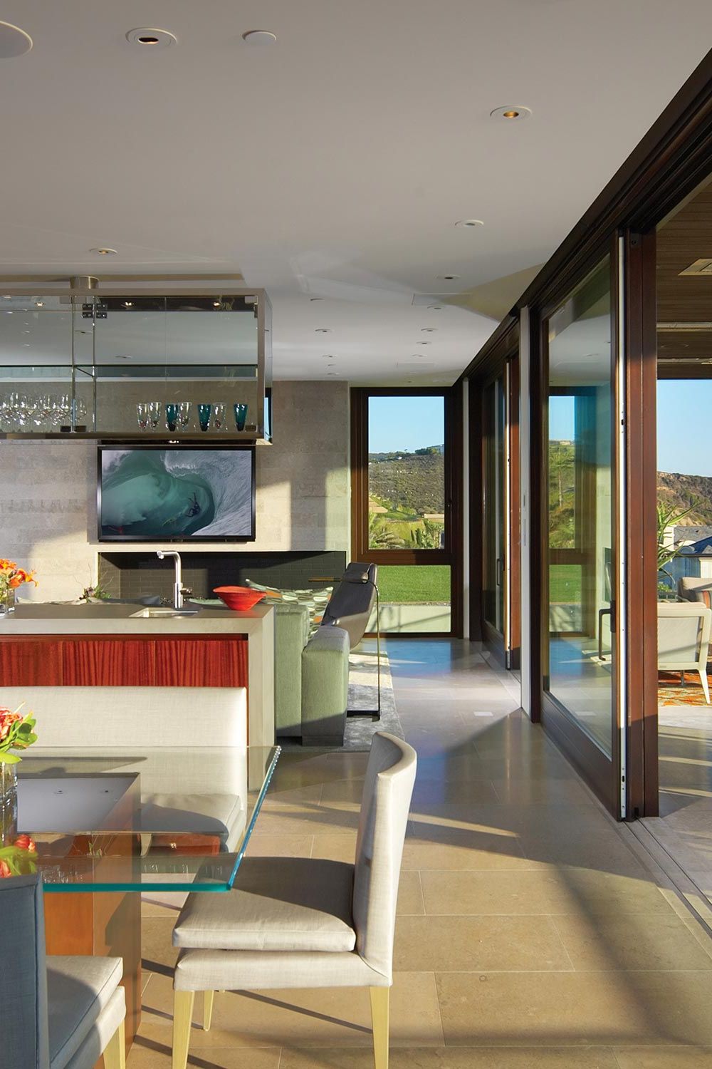 Open-concept home with kitchen, dining, and outdoor seating overlooking the ocean